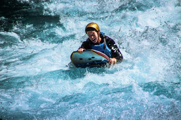 a man riding a wave on a surfboard in the water