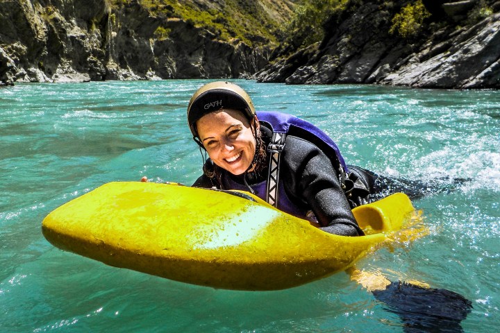 a person riding a surf board on a body of water