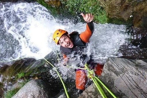 a person riding a wave on top of a rock