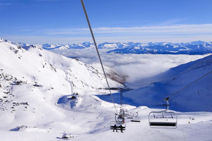 a group of people riding skis on top of a snow covered slope