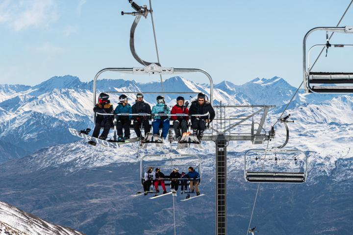 a group of people riding skis on top of a snow covered mountain