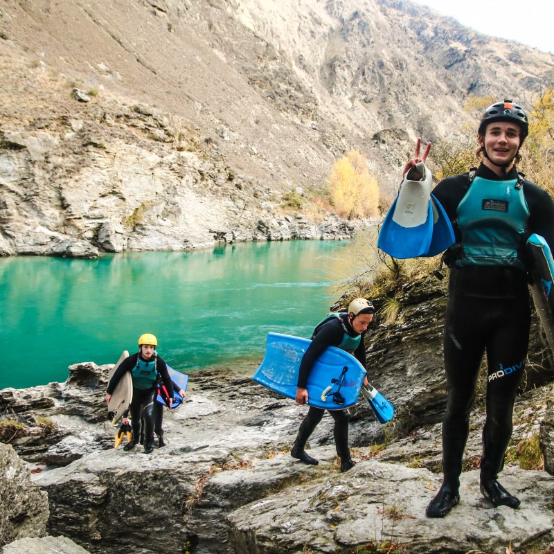 a group of people standing on a rocky beach