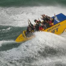 goldfields-jet-boats-3-250×250 a man riding a wave on a surfboard in the water