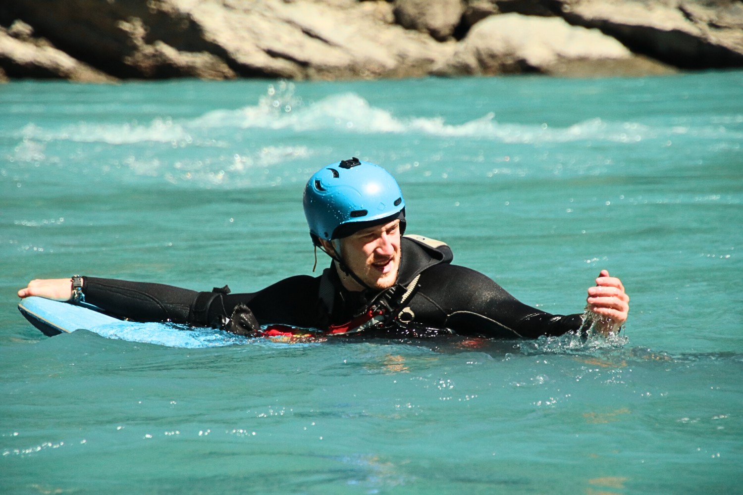 a person riding a surf board on a body of water