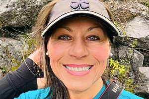 a woman wearing a hat and smiling at the camera