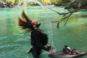 a person standing next to a body of water